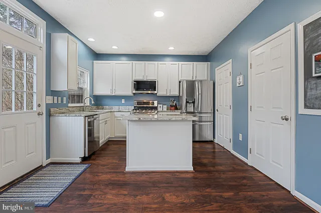 a open kitchen with granite countertop a sink and counter space