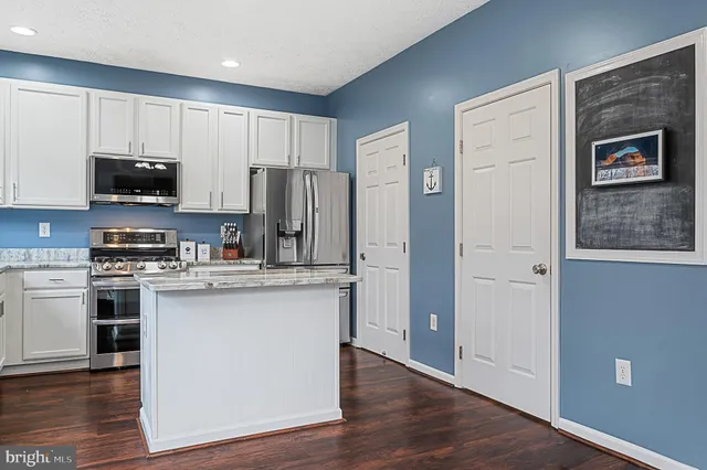 a spacious bedroom with a bed and a chandelier
