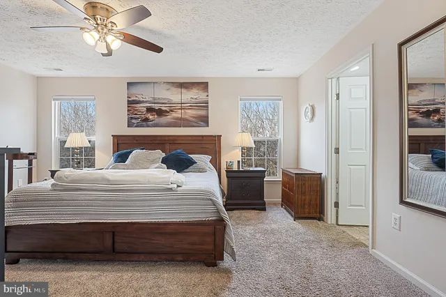 a living room with white couches and a flat screen tv