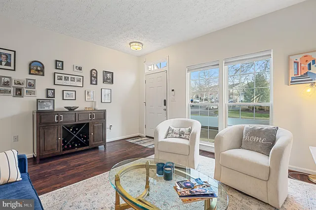 a view of hallway with stairs and wooden floor