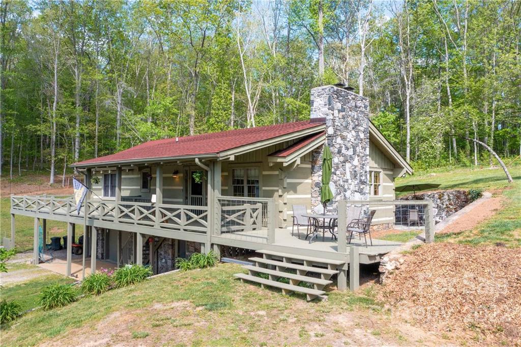 a view of a house with backyard porch and sitting area