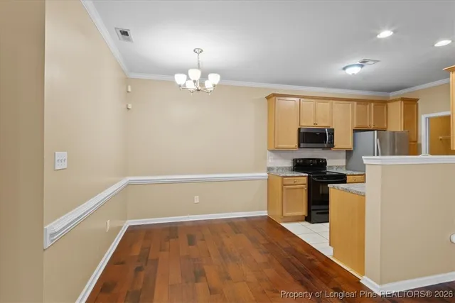 a view of a kitchen with stove and refrigerator