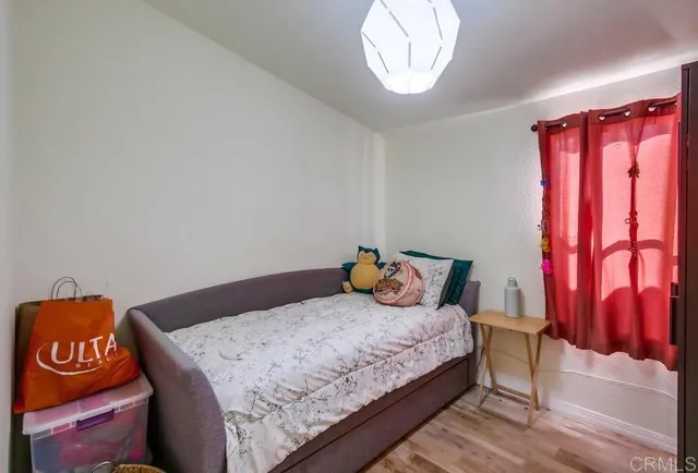 a bedroom with a bed and a window