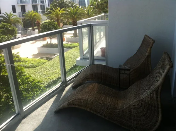 a view of a balcony with chair and table in balcony