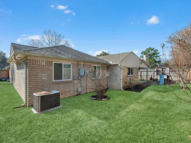 a view of a house with a yard and sitting area