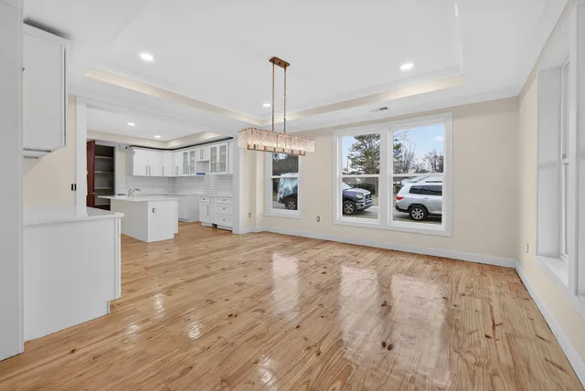 a view of a kitchen with a sink and a refrigerator