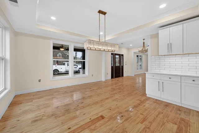 a view of a kitchen with refrigerator and cabinets