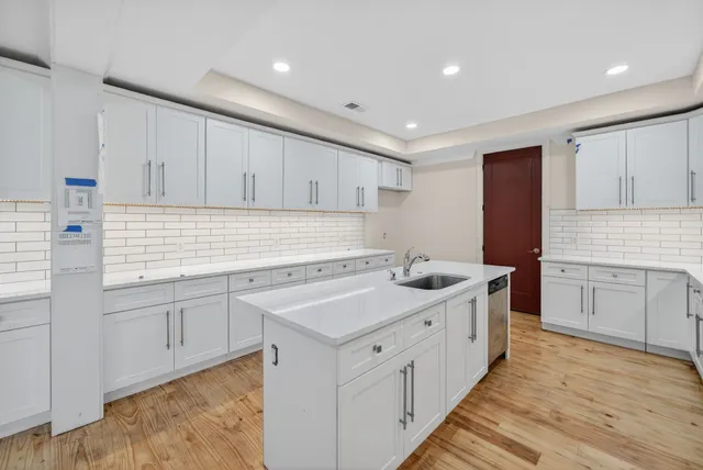 a kitchen with white cabinets