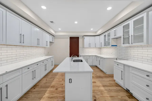 a kitchen with sink stove and cabinets