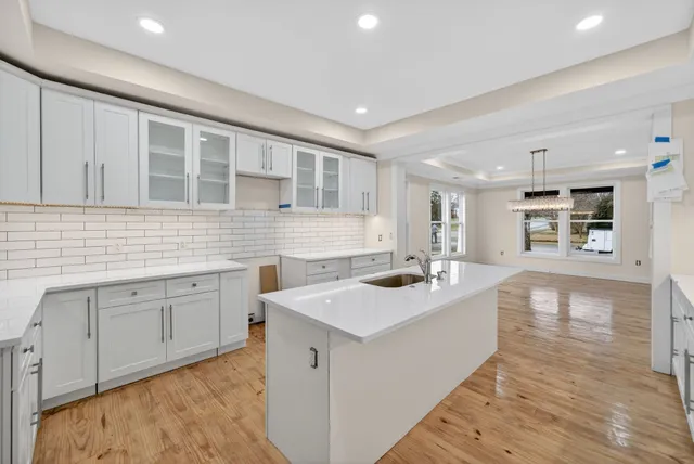 a kitchen with sink refrigerator and stove