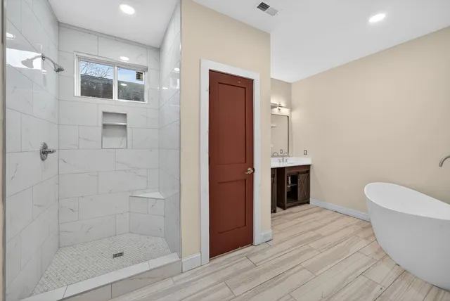 a bathroom with a bathtub and a shower