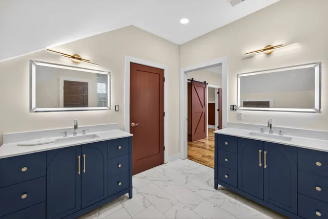 a bathroom with a double vanity sink and mirror