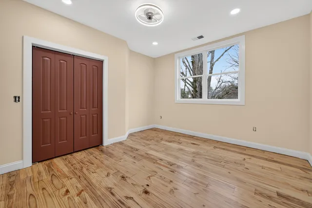 a bedroom with a bed and a window