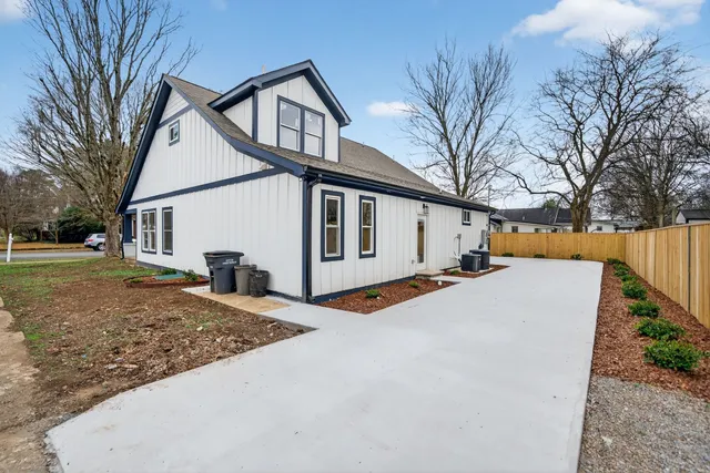 a view of a house with a yard covered in snow