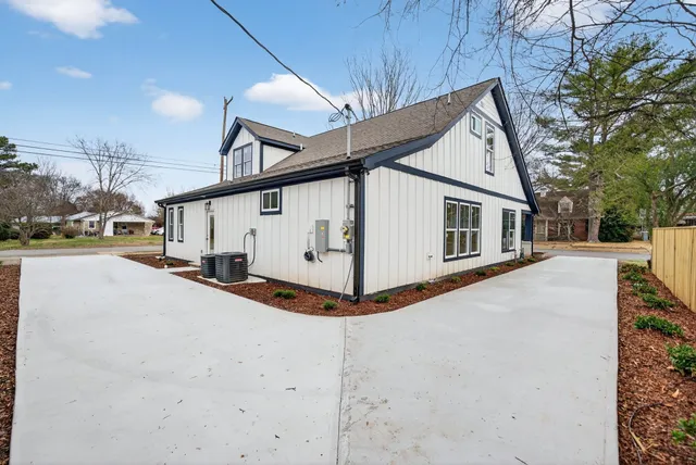 a view of a white house with a yard