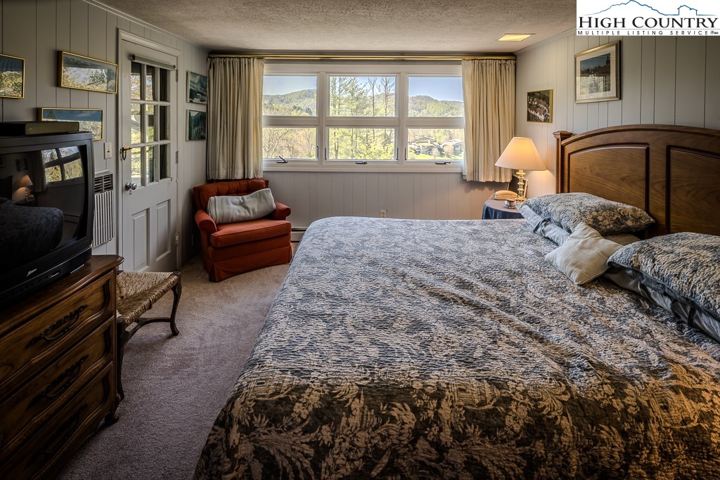 122 Hornbeam Road Boone, NC 28607 - Photo 20 of 28 a bedroom with a bed couch and a window