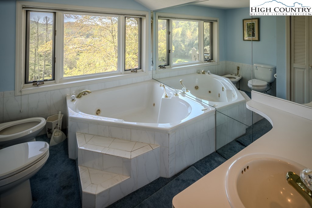 122 Hornbeam Road Boone, NC 28607 - Photo 22 of 28 a white bath tub sitting in a bathroom next to a toilet