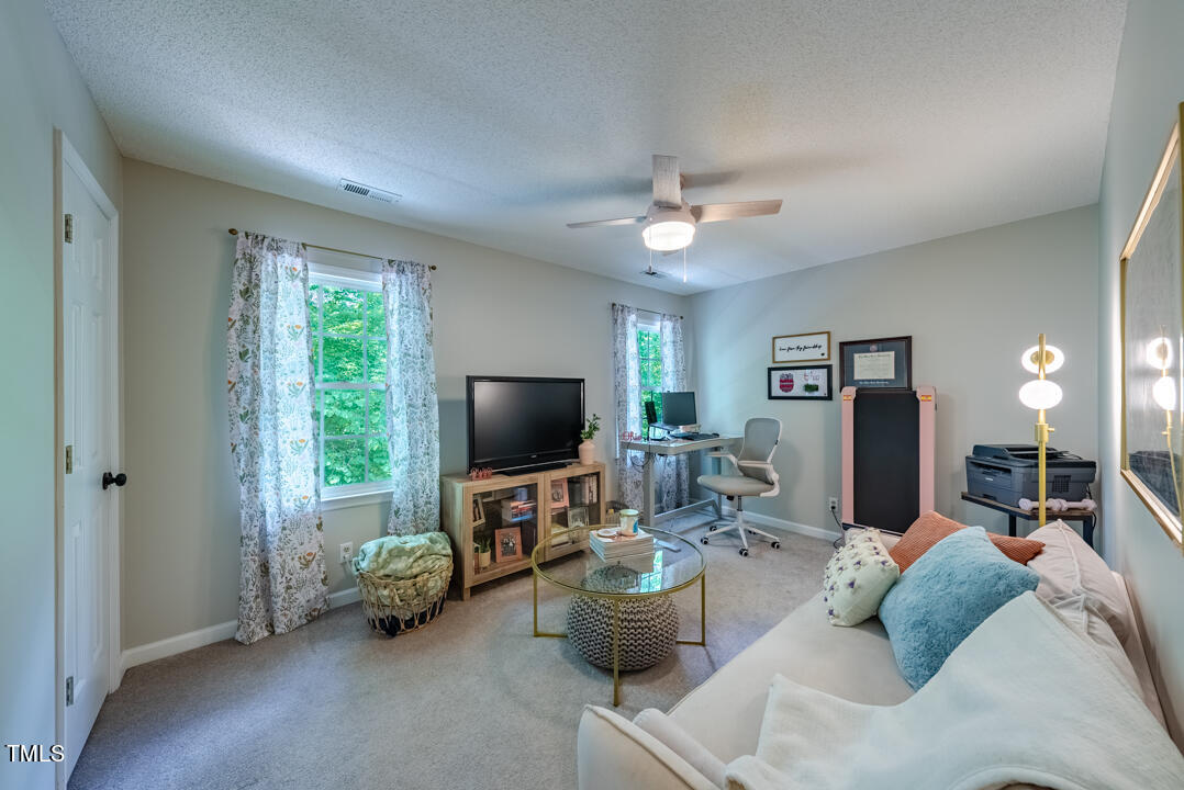 6806 Calais Drive Durham, NC 27712 - Photo 19 of 31 a living room with furniture and a flat screen tv