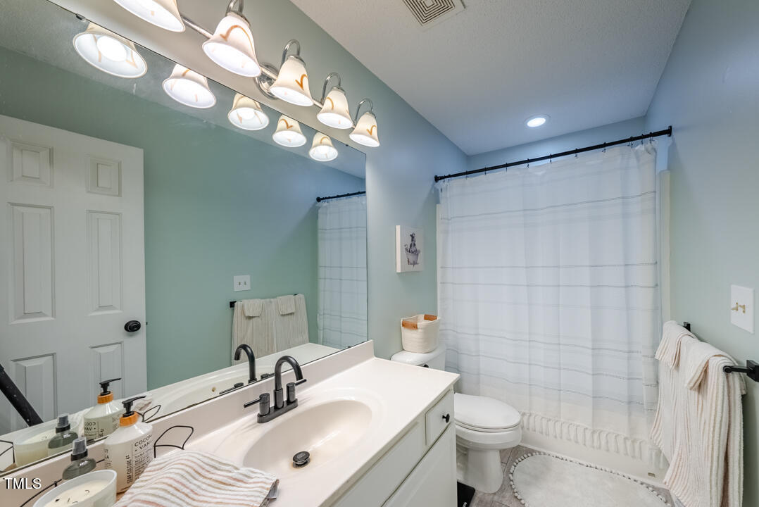 6806 Calais Drive Durham, NC 27712 - Photo 20 of 31 a bathroom with a sink a toilet and shower