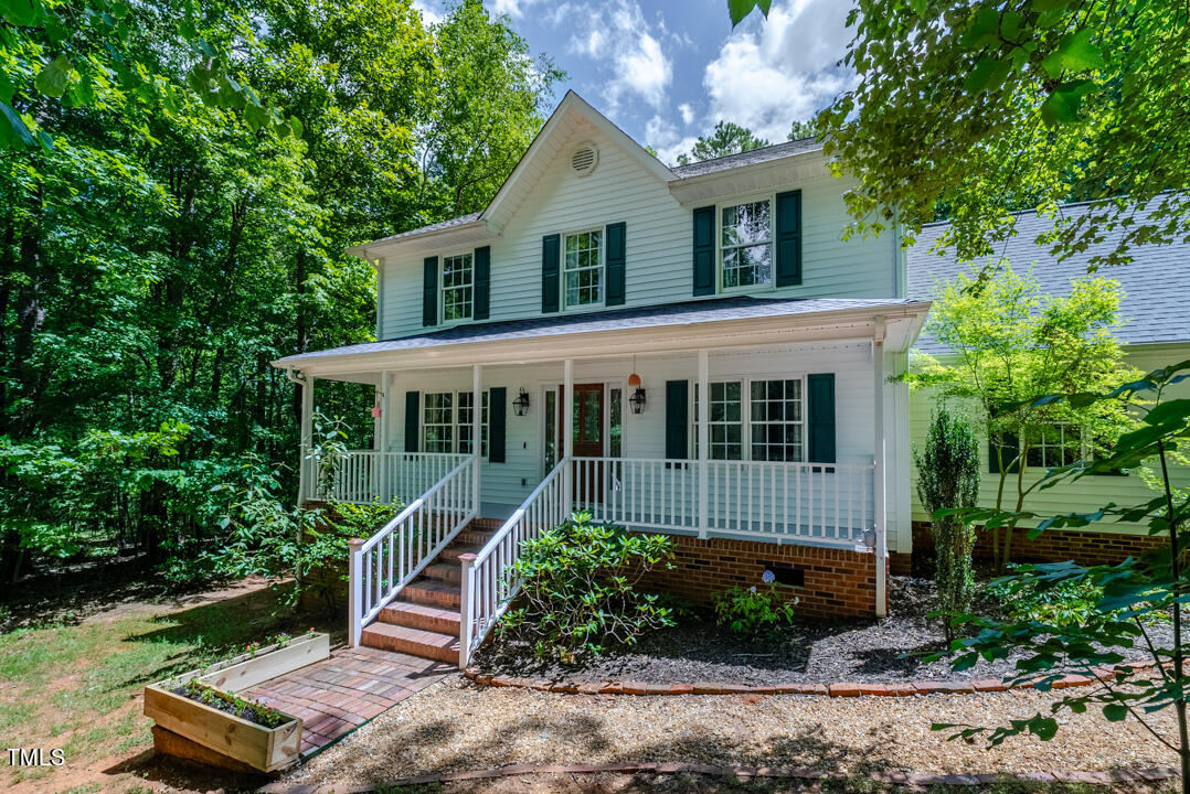 6806 Calais Drive Durham, NC 27712 - Photo 2 of 31 a house view with a garden space