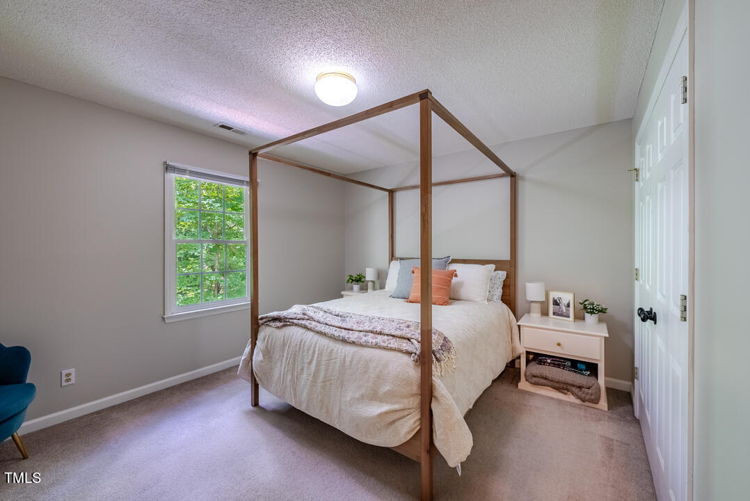 6806 Calais Drive Durham, NC 27712 - Photo 22 of 31 a bedroom with a bed and a window