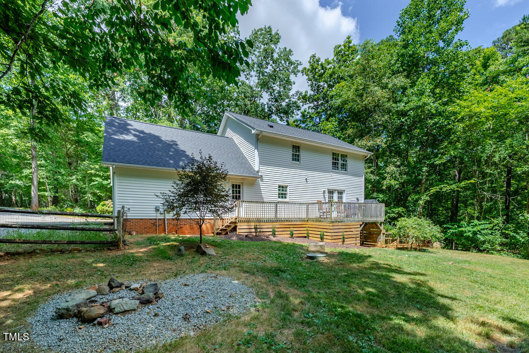 6806 Calais Drive Durham, NC 27712 - Photo 4 of 31 a front view of house with yard and trees in the background