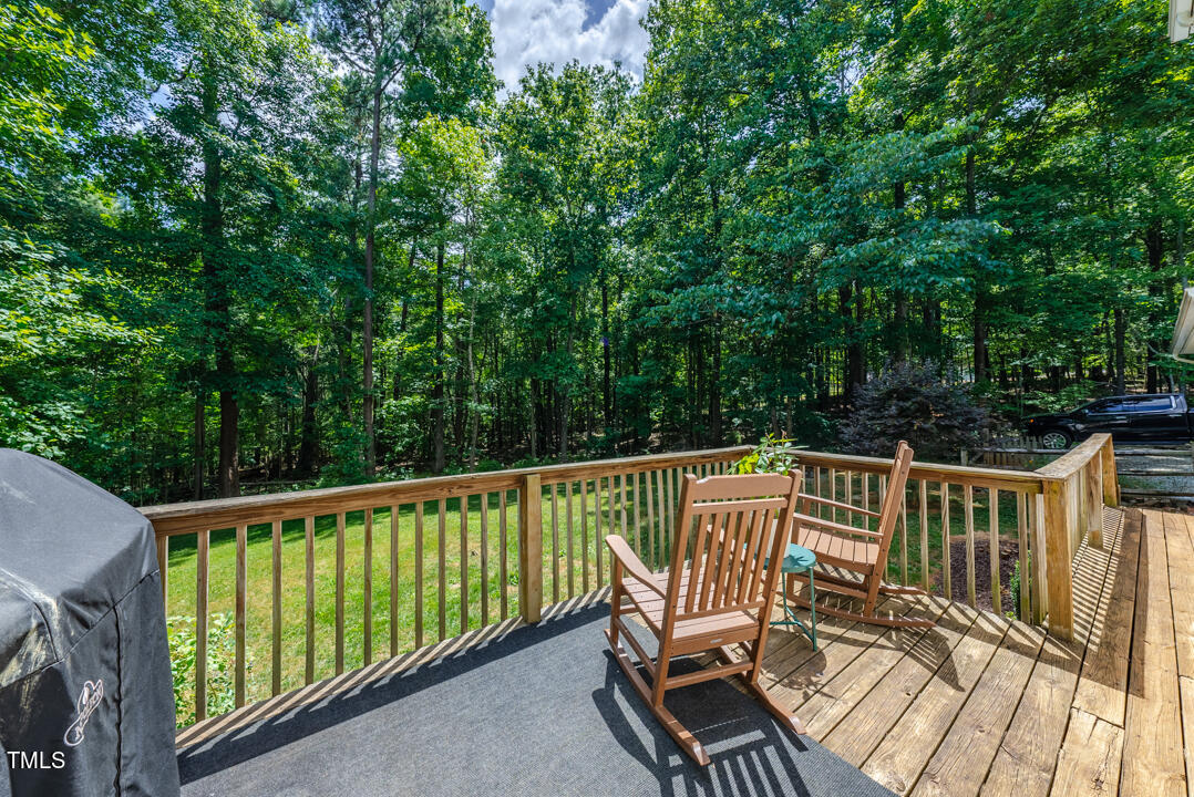 6806 Calais Drive Durham, NC 27712 - Photo 5 of 31 a view of a chair and table on the wooden floor