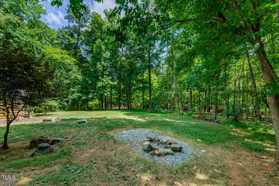6806 Calais Drive Durham, NC 27712 - Photo 6 of 31 a view of a grassy field with trees
