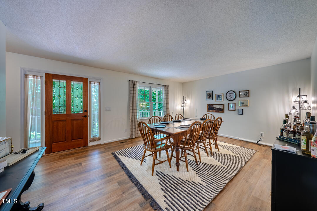 6806 Calais Drive Durham, NC 27712 - Photo 7 of 31 a dining room with furniture window and wooden floor