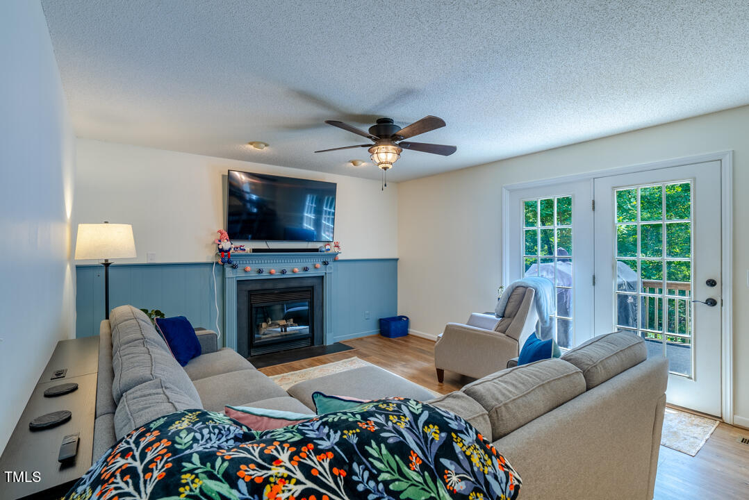 6806 Calais Drive Durham, NC 27712 - Photo 10 of 31 a living room with furniture fireplace and a flat screen tv
