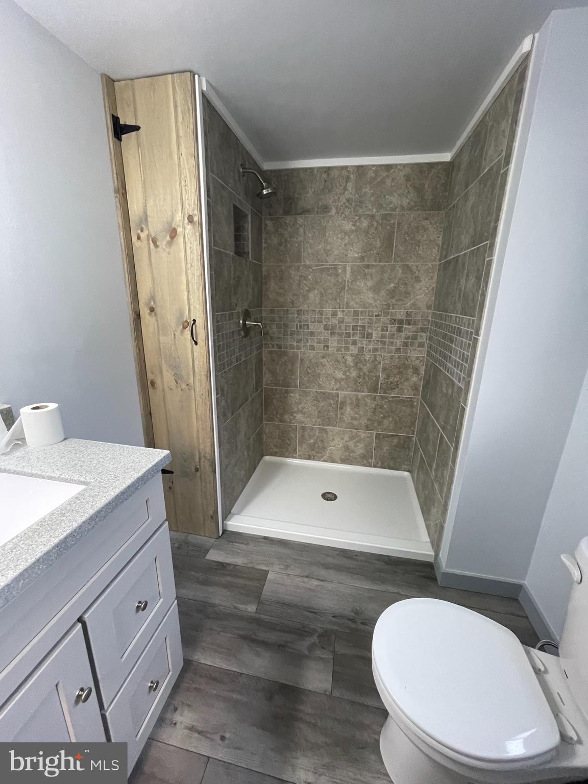 105 Spring Garden Street Leesport, PA 19533 - Photo 5 of 16 a bathroom with a granite countertop sink toilet and shower