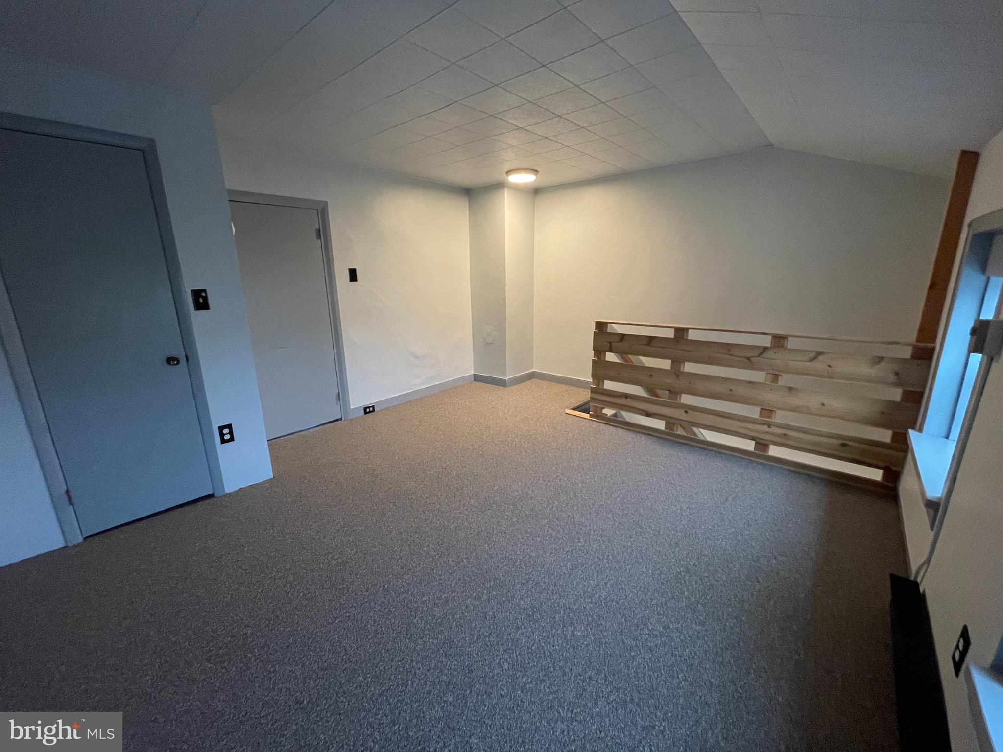 105 Spring Garden Street Leesport, PA 19533 - Photo 8 of 16 a view of room with stairs and a wooden floor