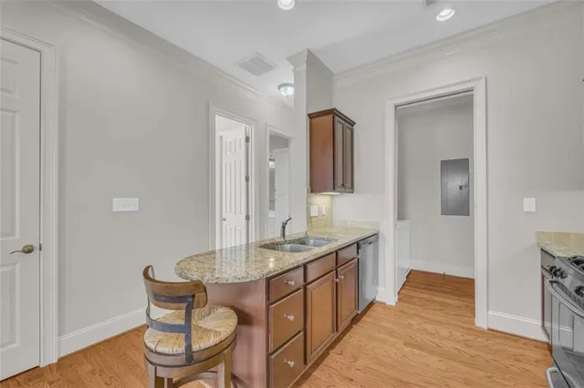a kitchen with sink stove top oven and microwave