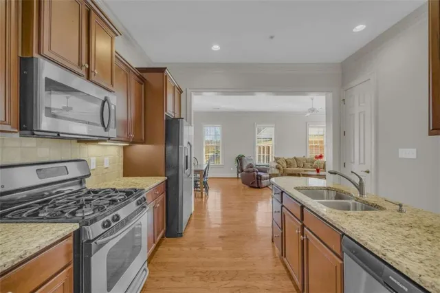 a kitchen with sink refrigerator and stove