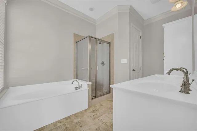 a spacious bathroom with a double vanity sink a toilet a a mirror and a bathtub