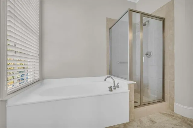 a bathroom with a bathtub and shower