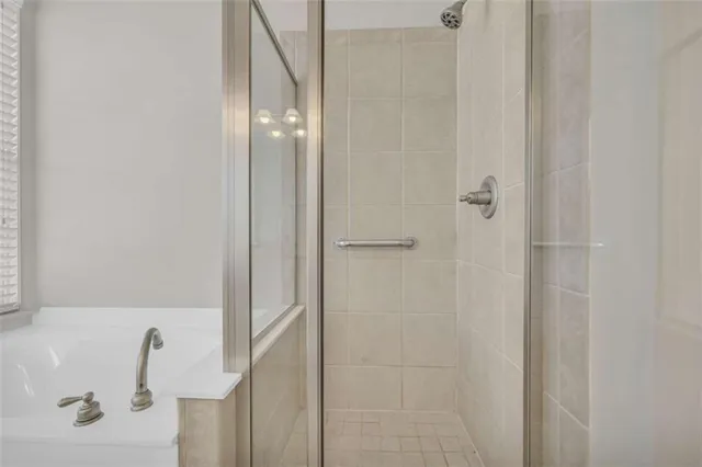 a bathroom with a shower a toilet and a shower