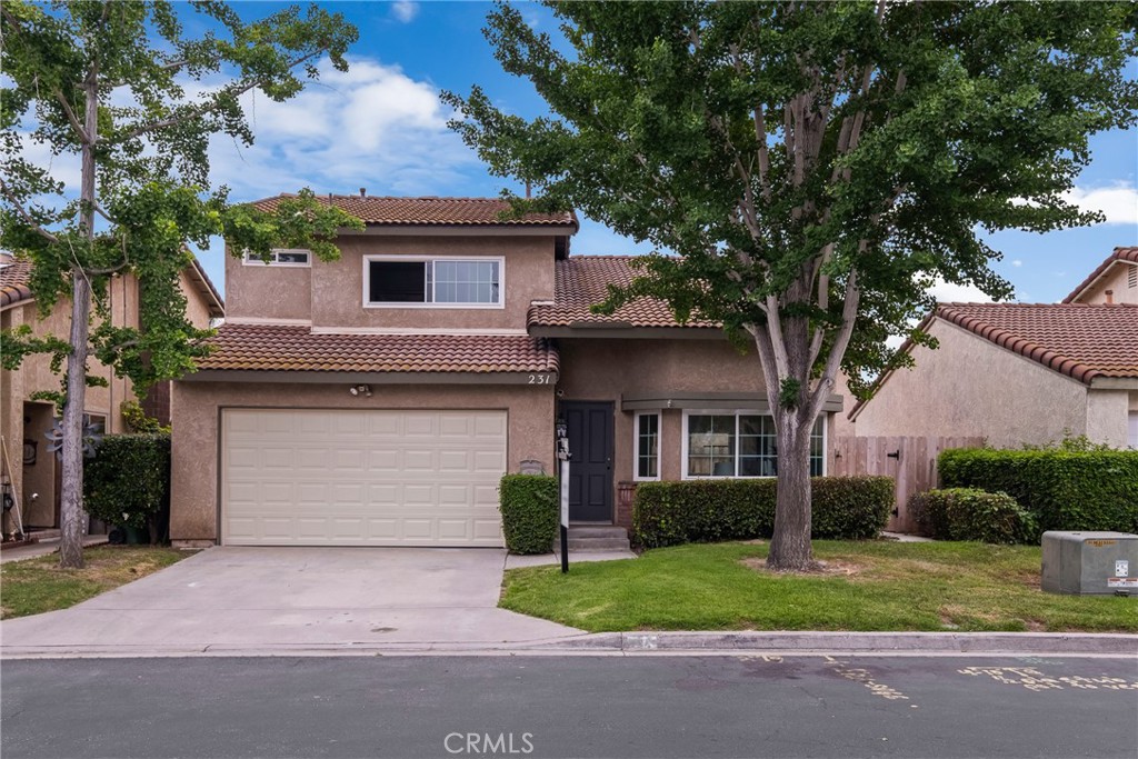 231 Argus Way Oceanside, CA 92057 - Photo 1 of 1 a front view of a house with a yard and garage