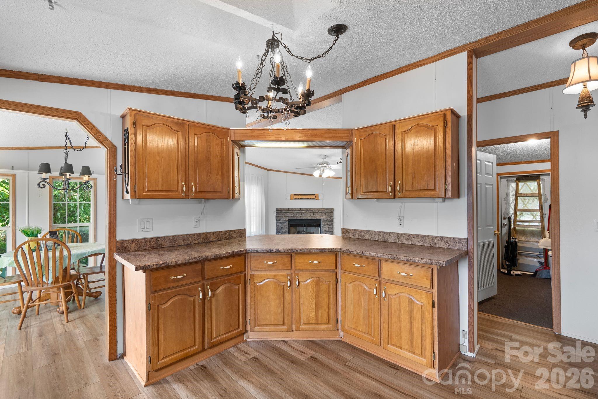 133 Spivey Mountain Road Asheville, NC 28806 - Photo 10 of 40 a kitchen with a sink cabinets and wooden floor