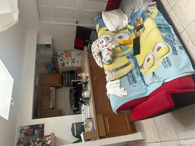 104-29 Roosevelt Avenue Queens, NY 11368 - Photo 14 of 23 a bedroom with furniture and a wooden floor