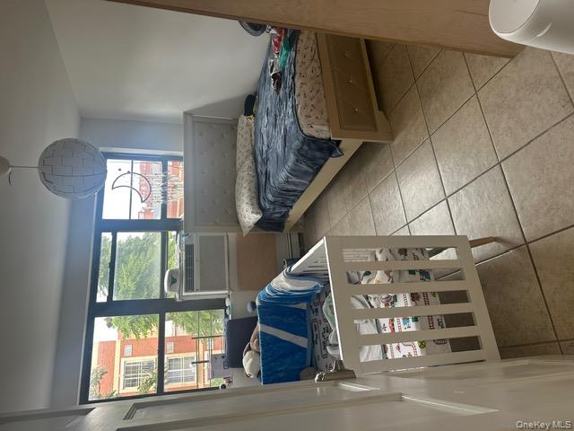 104-29 Roosevelt Avenue Queens, NY 11368 - Photo 15 of 23 a bedroom with a bed and a window