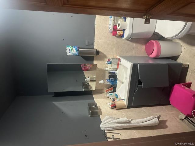 104-29 Roosevelt Avenue Queens, NY 11368 - Photo 17 of 23 a bathroom with a sink mirror vanity and toilet