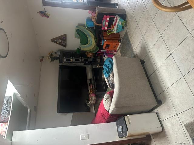 104-29 Roosevelt Avenue Queens, NY 11368 - Photo 18 of 23 a living room with furniture and a flat screen tv