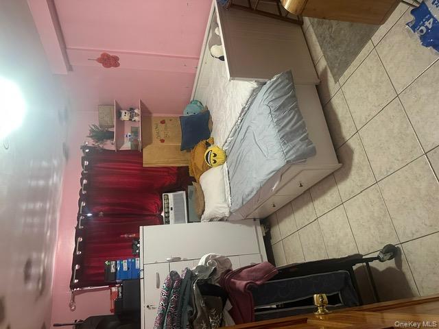 104-29 Roosevelt Avenue Queens, NY 11368 - Photo 20 of 23 a bedroom with a bed and a stove