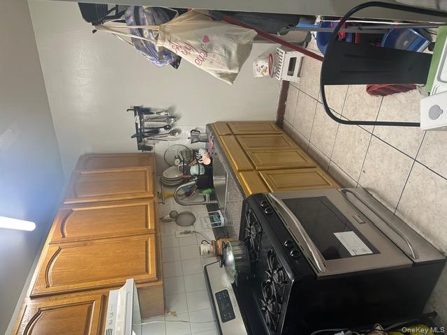 104-29 Roosevelt Avenue Queens, NY 11368 - Photo 2 of 23 a kitchen with stainless steel appliances granite countertop a stove and a sink