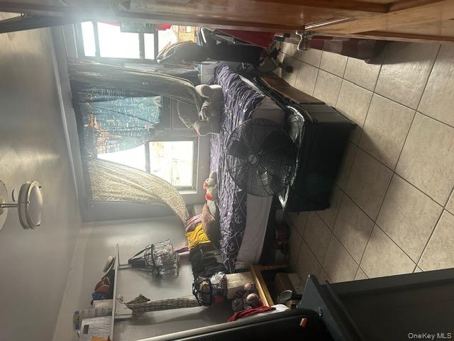 104-29 Roosevelt Avenue Queens, NY 11368 - Photo 21 of 23 a bed room with a bed and a window