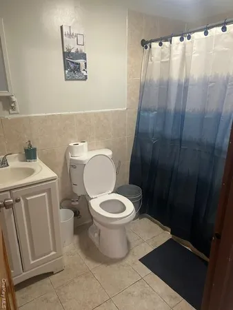 a white toilet sitting next to a bathroom sink