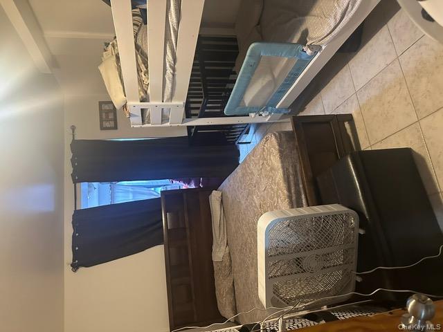 104-29 Roosevelt Avenue Queens, NY 11368 - Photo 7 of 23 a bedroom with a bed and a mirror