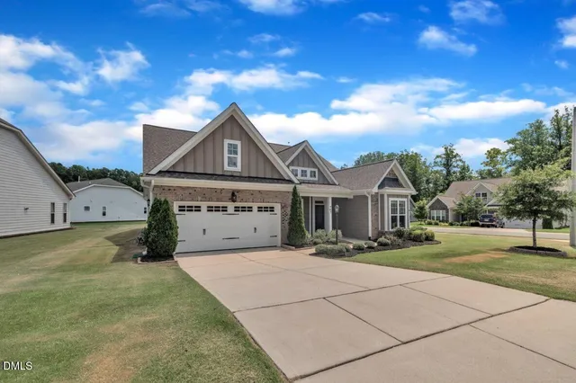 a kitchen with granite countertop white cabinets and stainless steel appliances