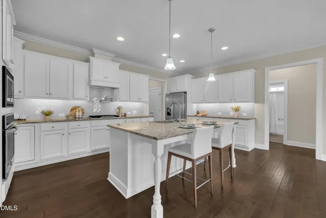 a kitchen with granite countertop white cabinets and a white stove